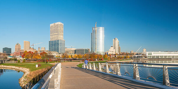 Milwaukee skyline  with city reflection in lake Michigan and harbor pier.